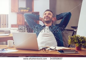 Satisfied man sitting at desk working